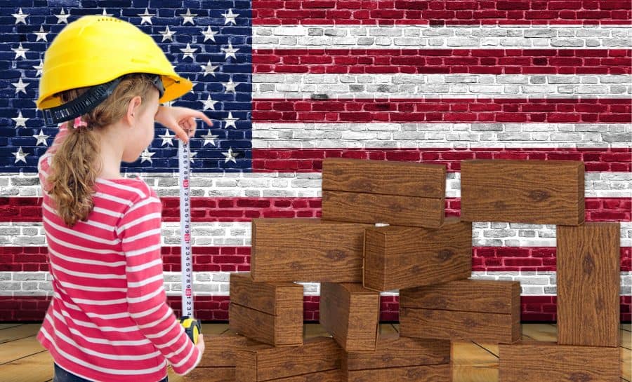 Giant Building Blocks-Timber Blocks-Made in America - Girl, wearing a hardhat, holding a measuring tape, with a US flag background.