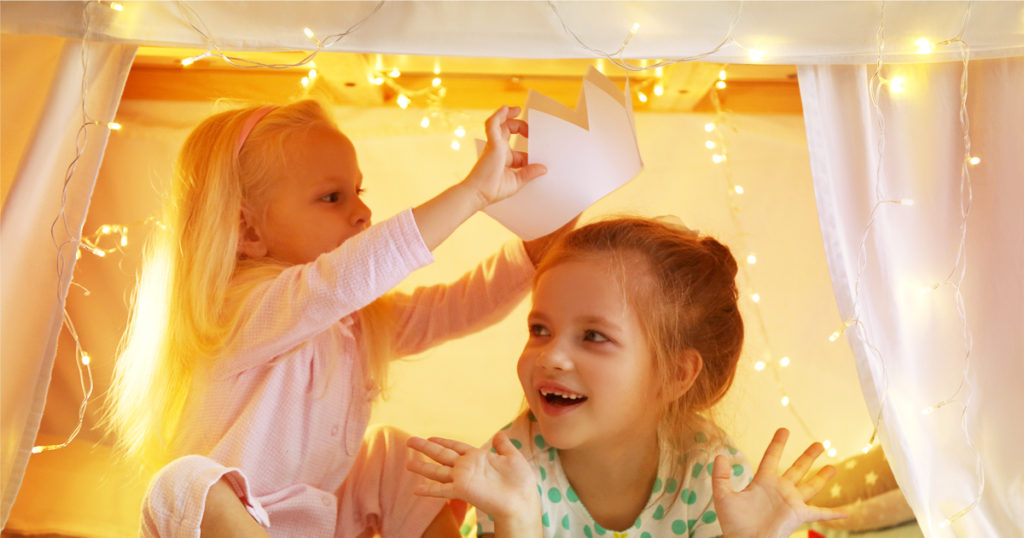 Imagination and creativity- Walt Disney Quote with girls playing under a make-believe tent with a paper crown