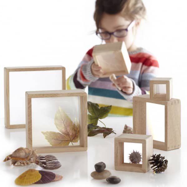 wooden square blocks-magnification blocks-wooden nesting blocks-young girl using the blocks to examine something found in nature