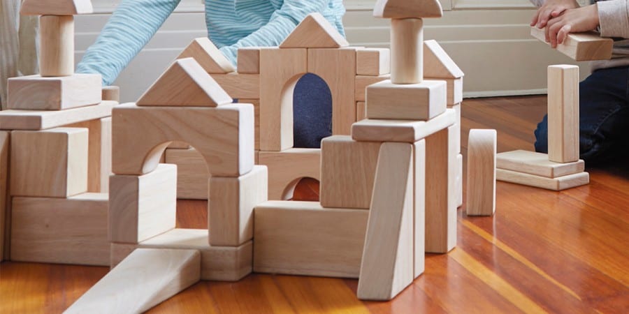 block play-kids building elaborate structures with wooden building blocks