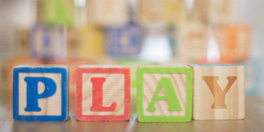 language activities for preschoolers-block play-stack of alphabet blocks that spell play