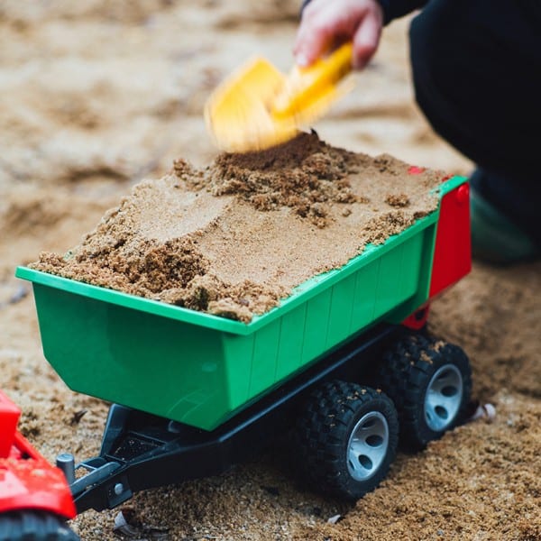 constructive play- stem building activities-toddler playing the sand with their dump truck and shovel