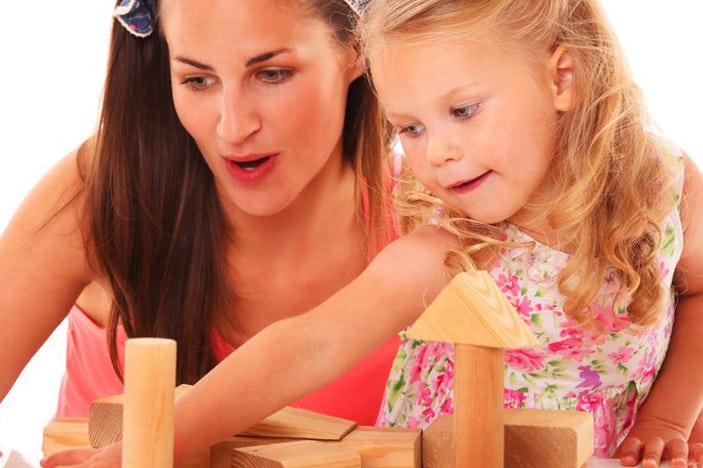 cognitive development in preschoolers-mother and daughter engaged in block play