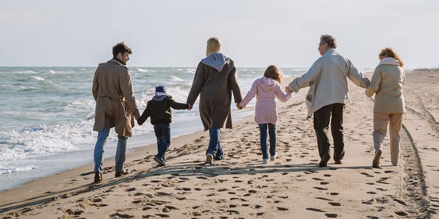 screen time alternatives-family taking a walk on the beach